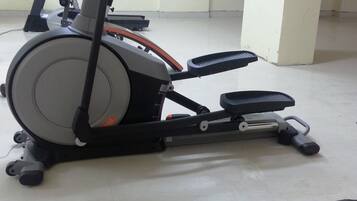 An exercise machine and a black mat with "CENTURY" written on it.