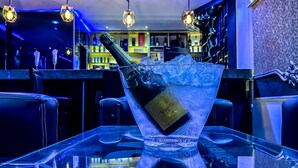 A bar area with a bottle of champagne in a glass of ice. - Parkview Astoria Hotel (Lagos)