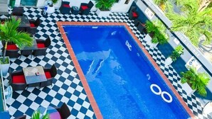A modern building with a pool area, outdoor seating, and a wellness center. - Parkview Astoria Hotel (Lagos)