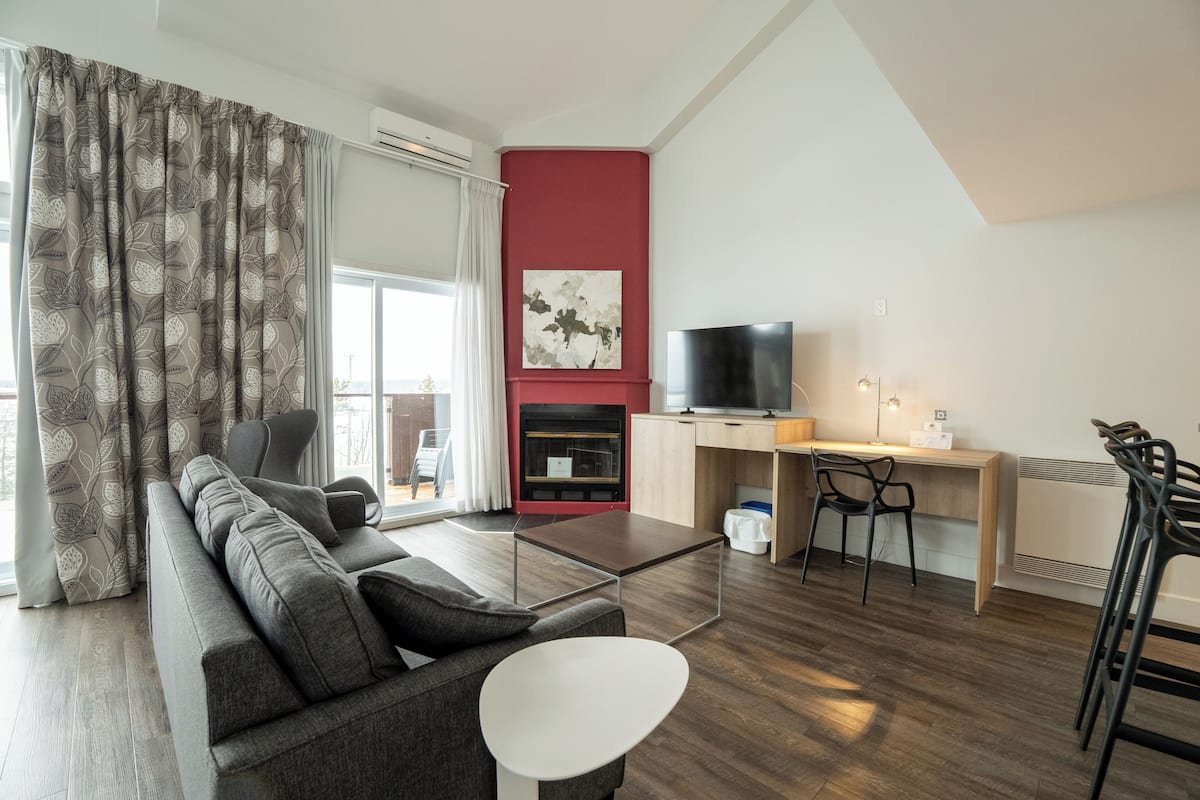 Suite, 1 King Bed, Kitchenette, Lake View (with Sofabed) | Living area | 30-inch plasma TV with cable channels, TV