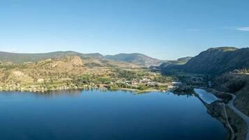 A lake surrounded by hills with a small town in the foreground.