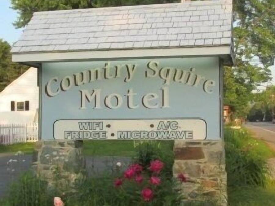 A motel sign with amenities including WiFi, fridge, and microwave.