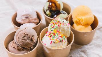 Six bowls of ice cream in different flavors and toppings.