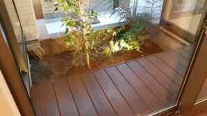 A wooden deck with a small garden area. - Tokyo Guest House 2020 (Tokyo)