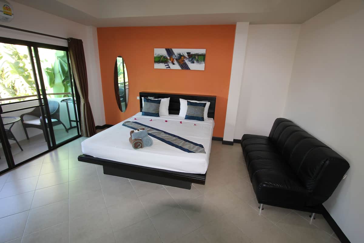 Estudio Deluxe, 1 cama King size, balcón, vista al jardín | Área de sala de estar | Televisión LCD de 32 pulgadas con canales por cable y televisión