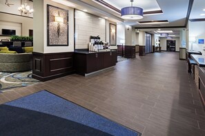 A spacious hotel lobby with a reception desk, seating area, and a large chandelier. - Holiday Inn Express & Suites Glenpool-Tulsa South by IHG (Glenpool)