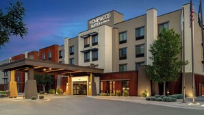 A modern hotel with a covered entrance, multiple floors, and a sign indicating it is a Homewood Suites by Hilton. - Homewood Suites By Hilton Billings, MT (Billings)