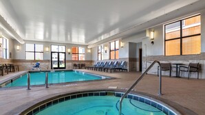 A large indoor swimming pool with multiple lanes, sunlit seating areas, and a clear view of the pool from the lounge. - Homewood Suites By Hilton Billings, MT (Billings)