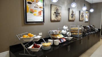 A buffet setup with various food items and a menu display.