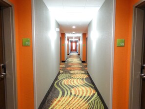 A hotel hallway with doors numbered 512 and 515, carpeted with a patterned design. - Holiday Inn Covington by IHG (Covington)