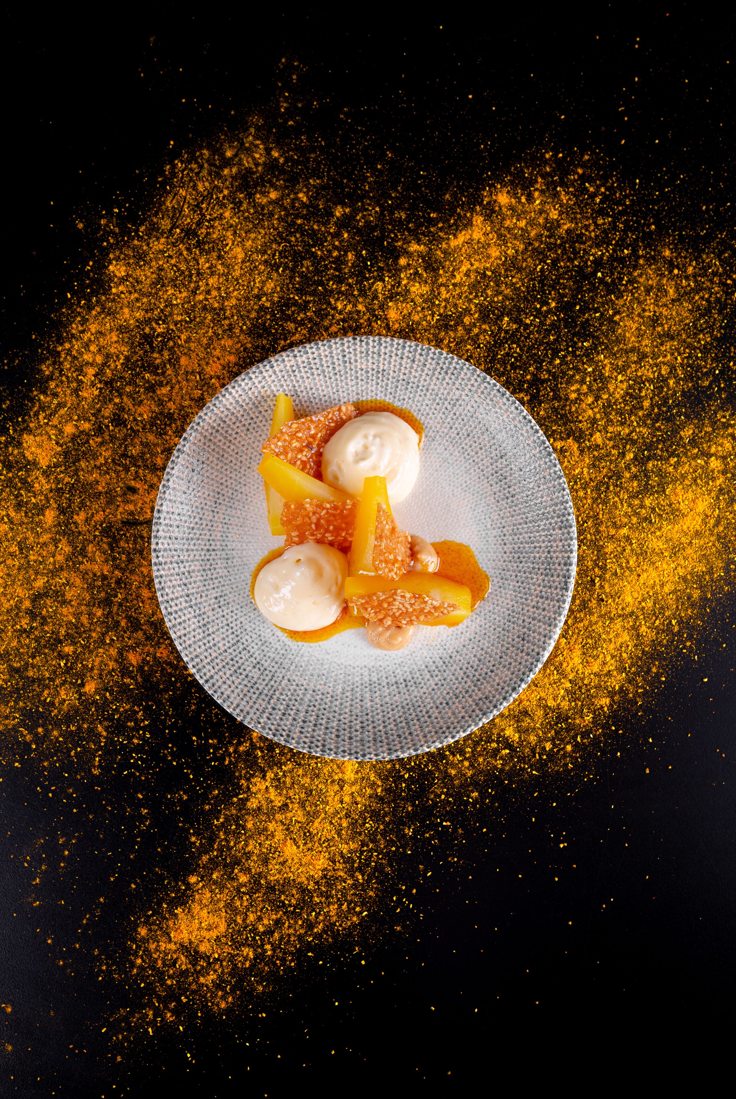 A plate with dessert on a textured surface.