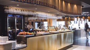 A buffet area with a variety of food items and a glass display. - Vox Hotel (Jonkoping)