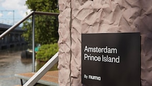 A sign with 'Amsterdam Prince Island' and 'By numa' text. - YAYS Amsterdam Prince Island by Numa (Amsterdam)