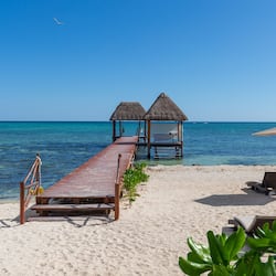 On the beach, white sand, sun-loungers, beach umbrellas
