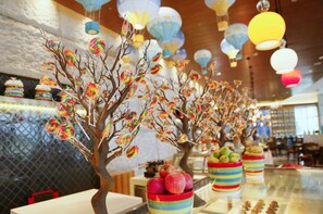 A restaurant interior with decorative trees and colorful hanging lanterns. - Shangri-La Qinhuangdao (Qinhuangdao)