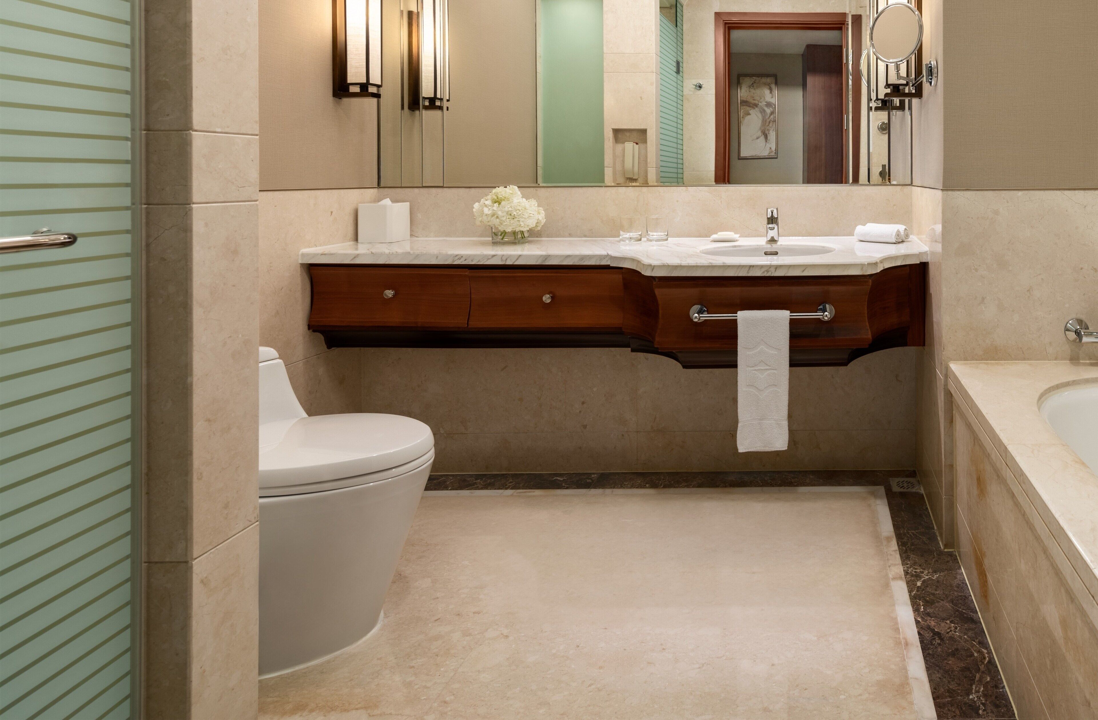 A bathroom with a toilet, sink, and bathtub.