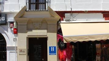 A building with a ground-floor shop and a second-floor entrance.