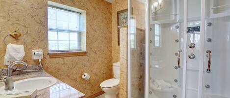 A bathroom with a sink, toilet, and a walk-in shower.
