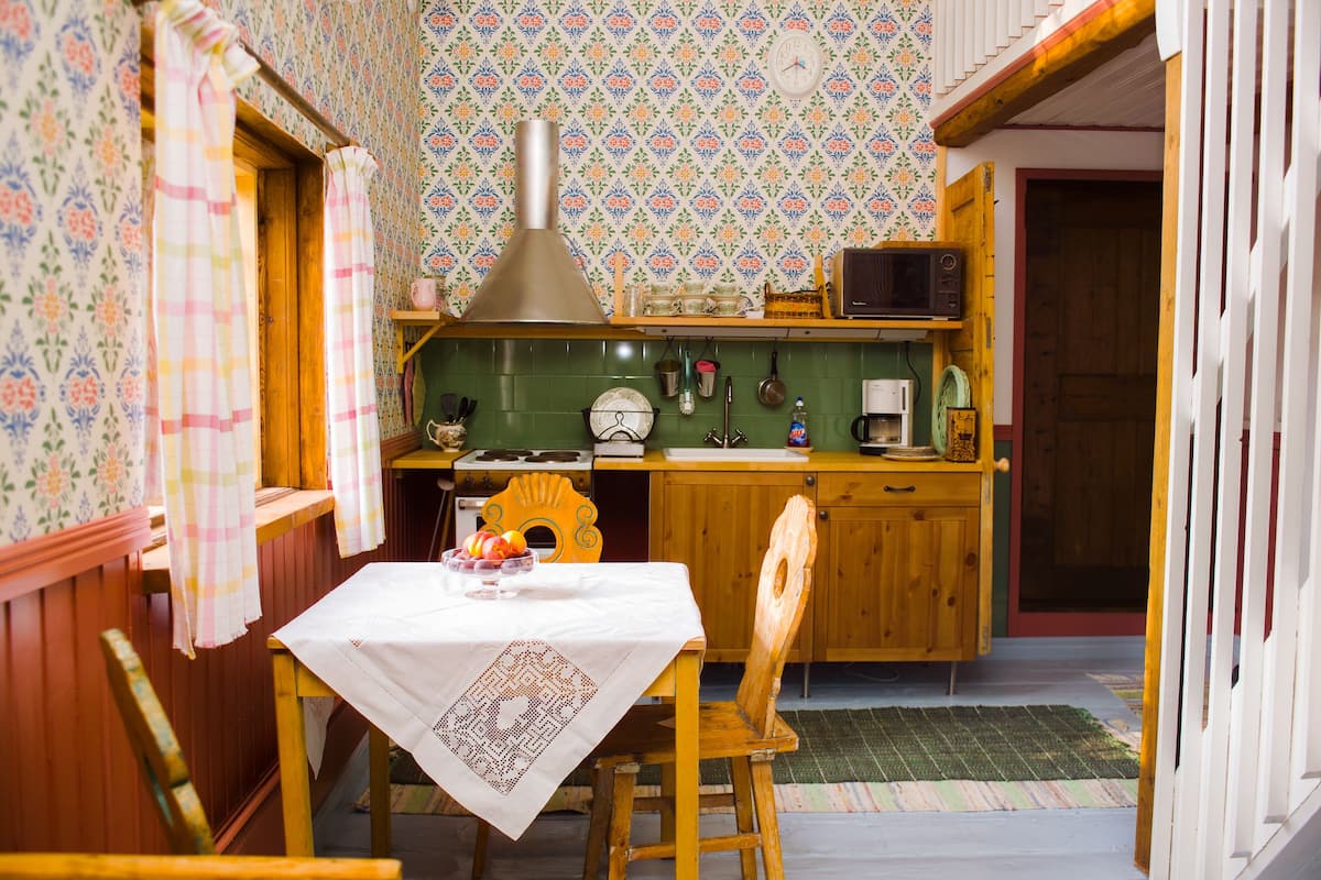 A kitchen with wooden cabinets, a microwave, and a sink.