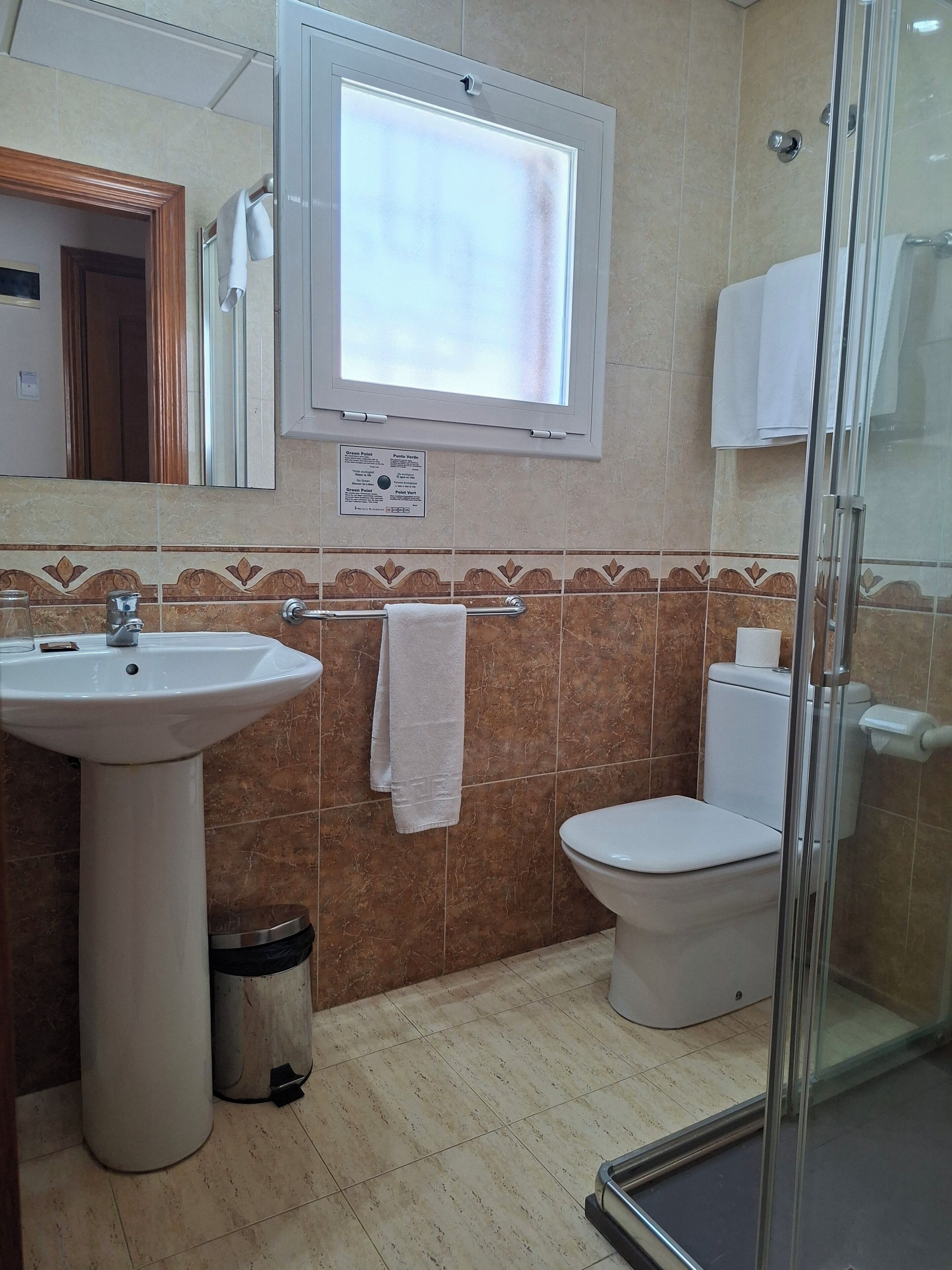 A bathroom with a sink, toilet, and shower.