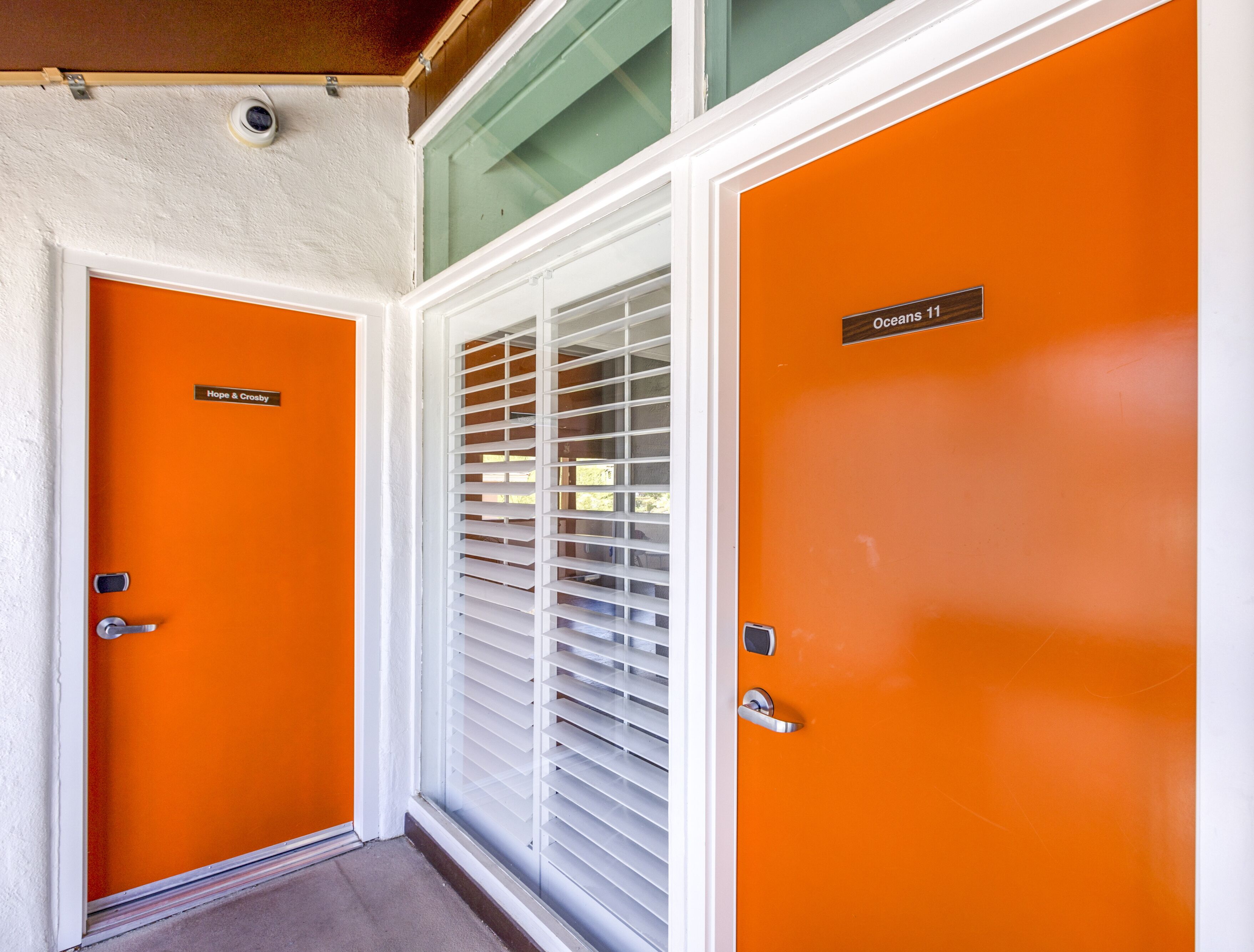 Two orange doors with a sign reading "Hope & Crosby" and "Oceans 11".
