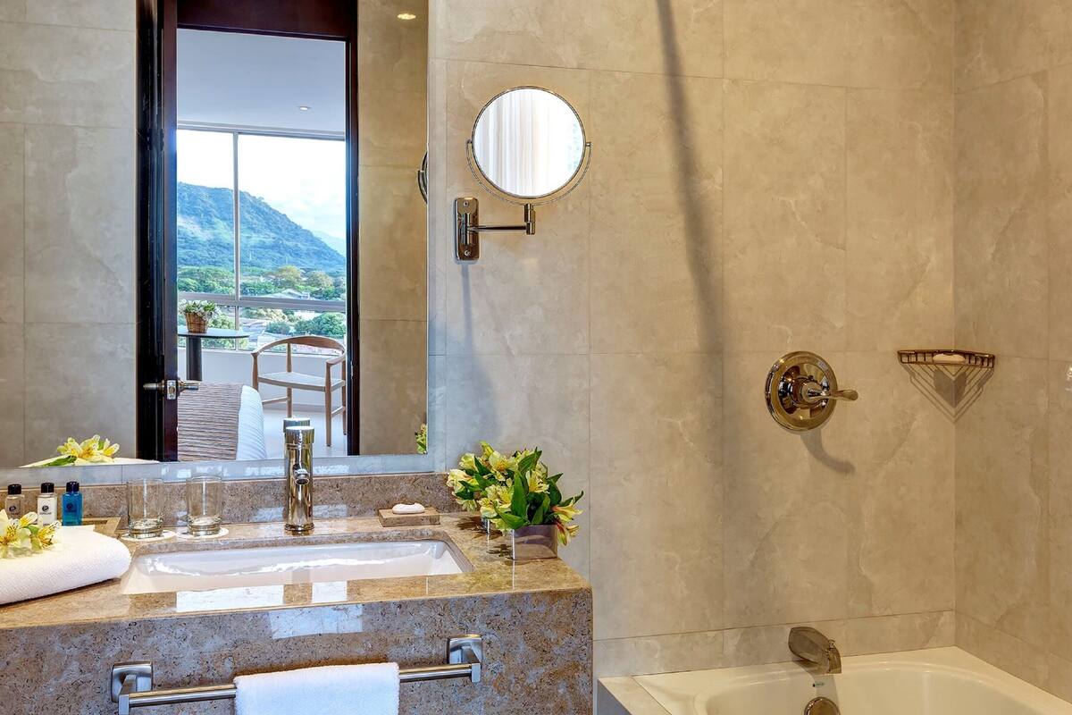 deluxe room, 1 king bed | bathroom | shower, rainfall showerhead, free toiletries, towels