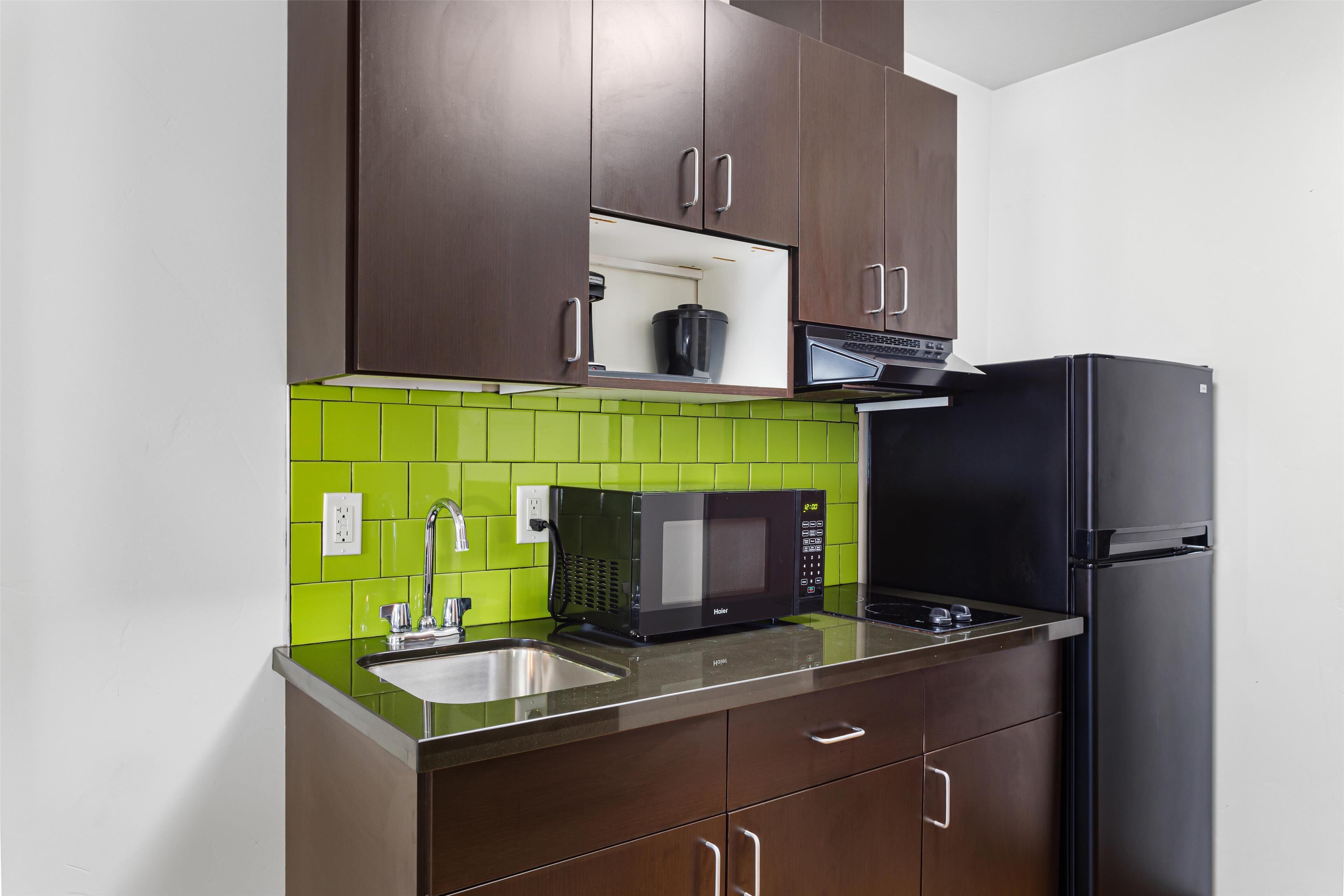 full-sized fridge, microwave, stovetop, coffee/tea maker