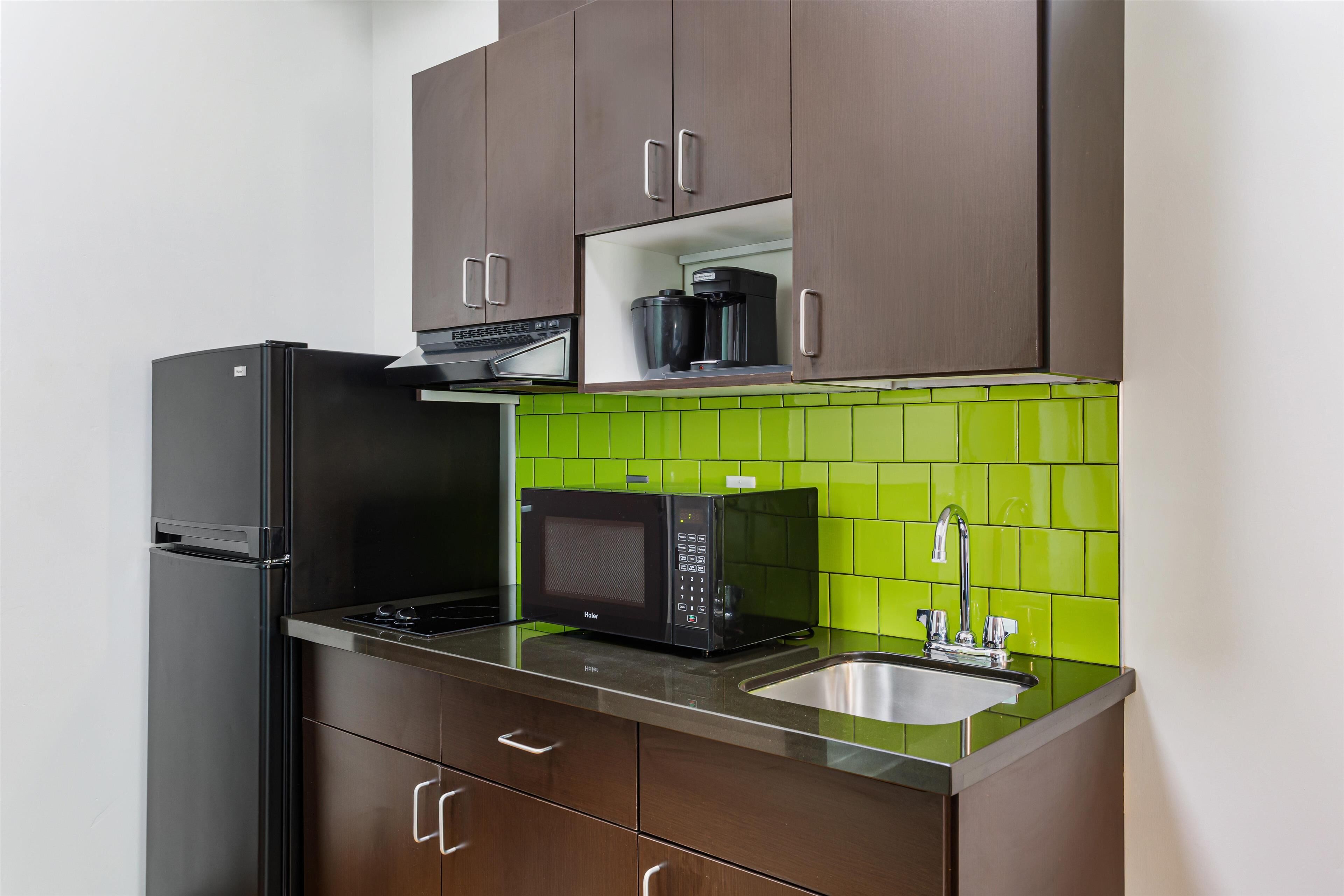 full-sized fridge, microwave, stovetop, coffee/tea maker