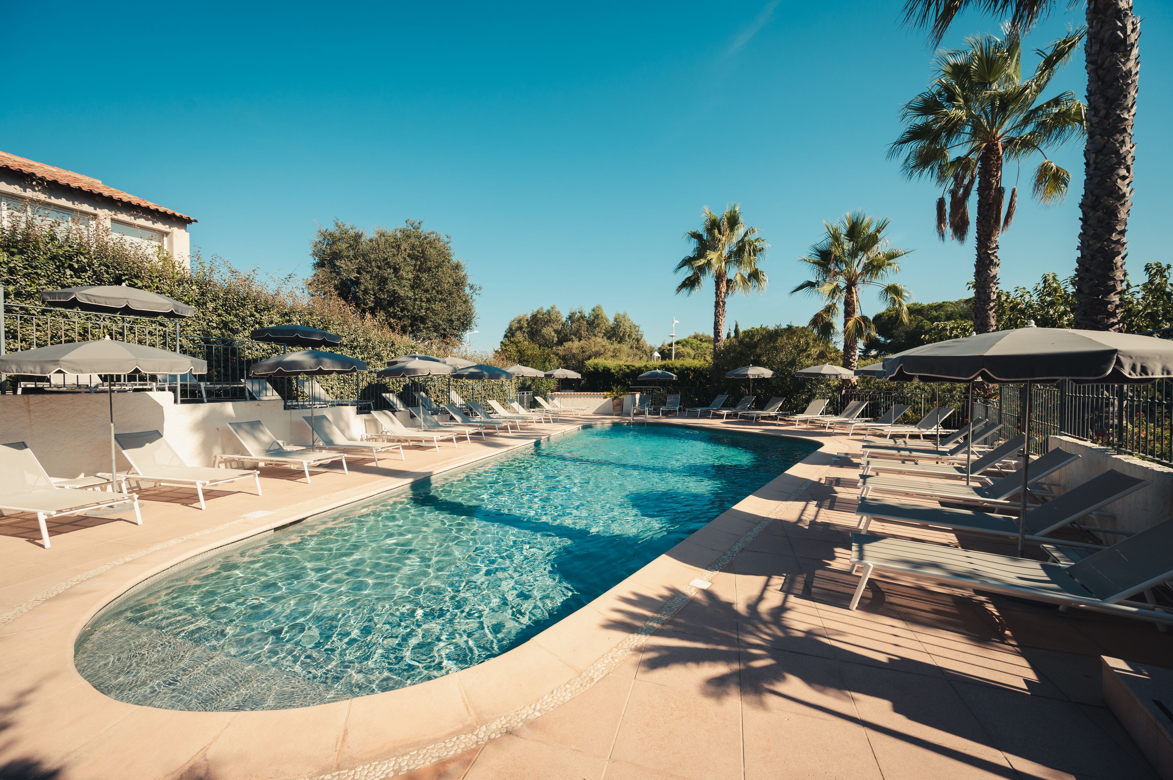 outdoor pool, pool umbrellas, pool loungers