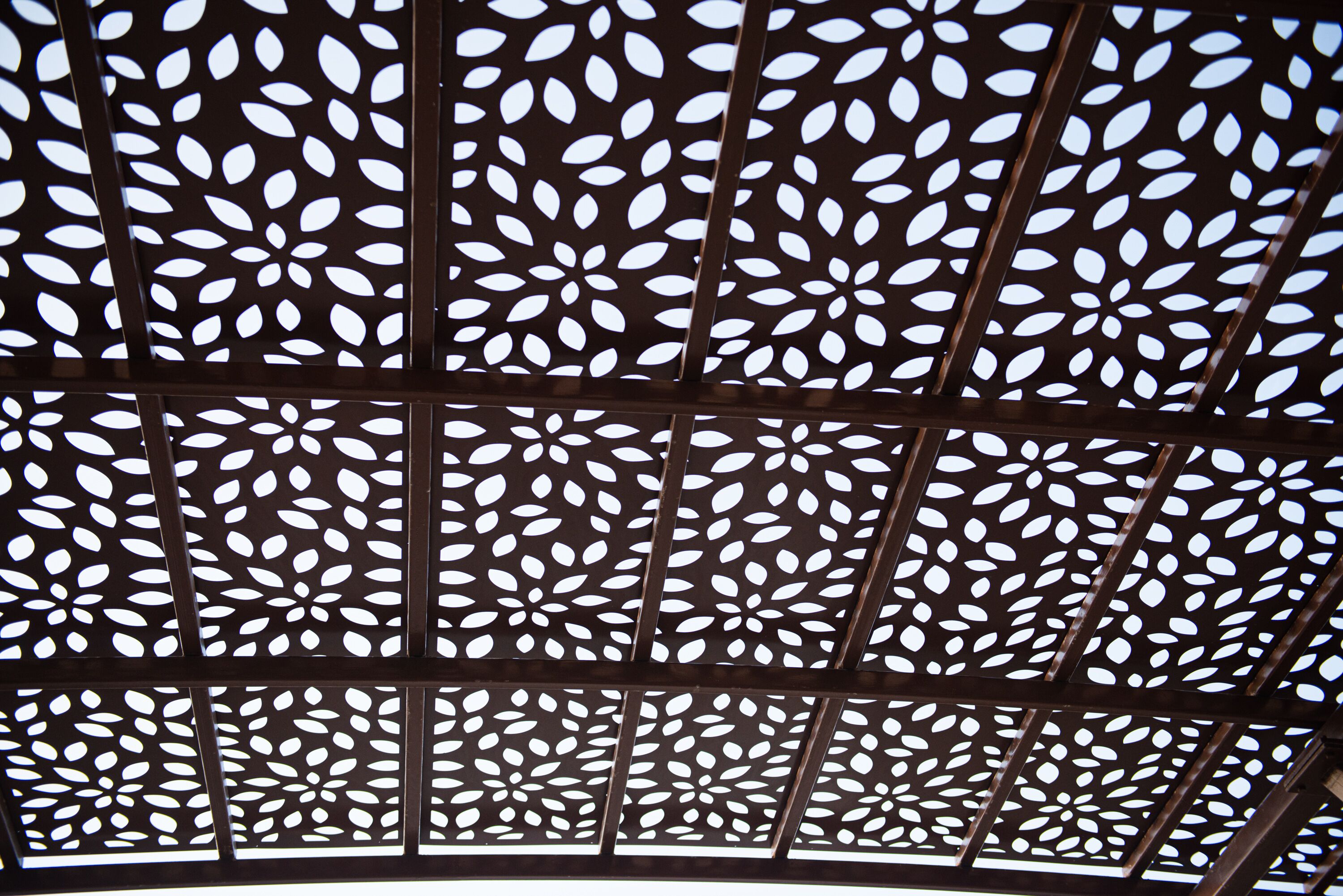 A ceiling with a geometric pattern of interlocking panels.