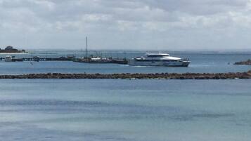 A marina with boats docked and a pier extending into the water.