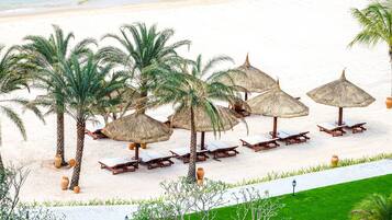Private beach, white sand, sun loungers, beach umbrellas