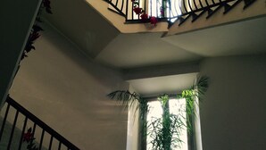 A multi-level staircase with black railings and red flowers. - B&B Nike (Syracuse)
