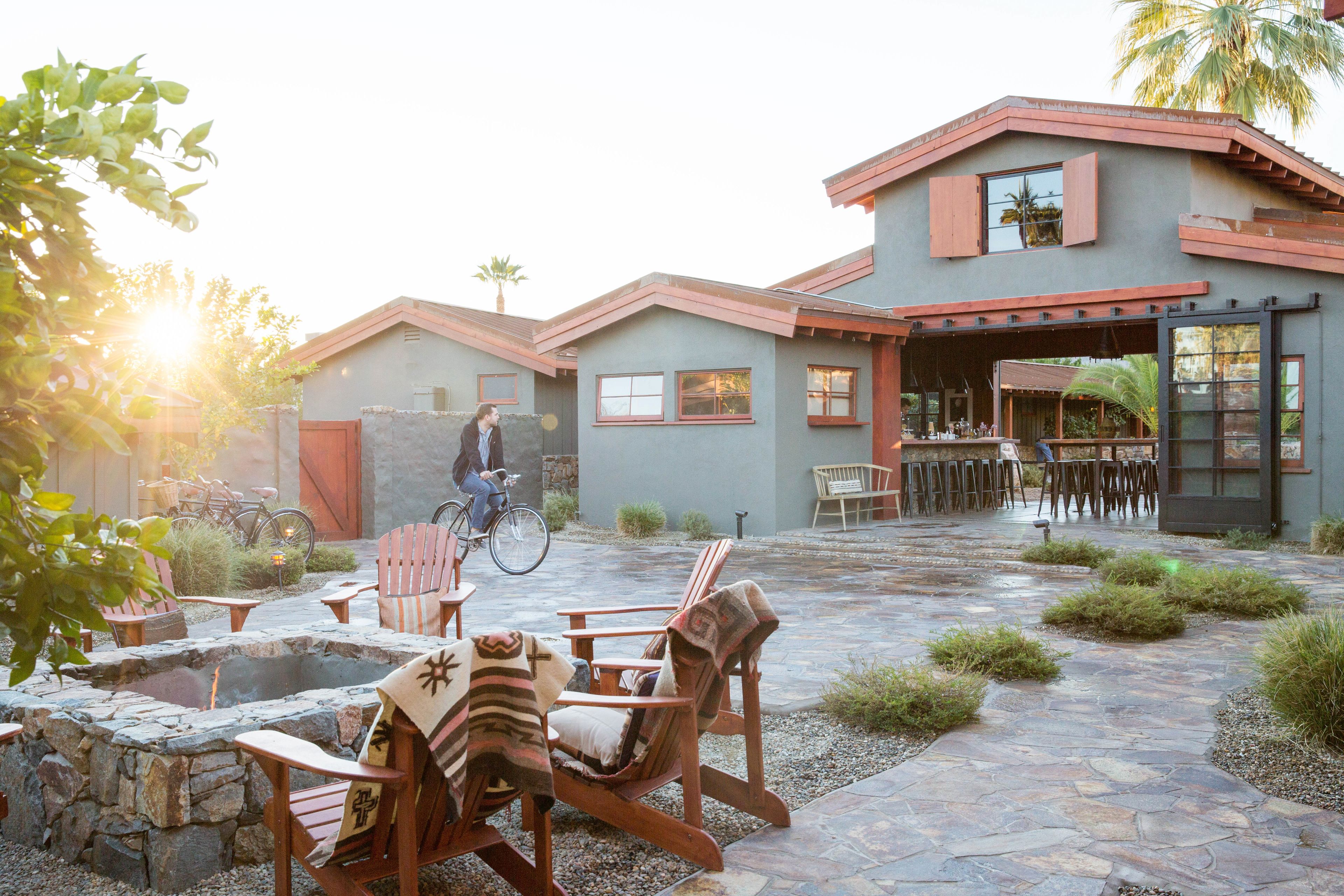 A patio area with outdoor seating, a fire pit, and a bicycle.
