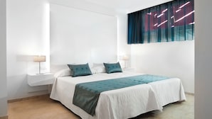 A neatly arranged bedroom with a large bed, two bedside tables with lamps, and a window with sheer curtains. - Kn Aparthotel Panoramica Heights (Adeje)