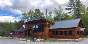 A wooden lodge with a metal roof, a covered porch, and a sign that reads "Becks." - Gore Mountain Lodge (North Creek)