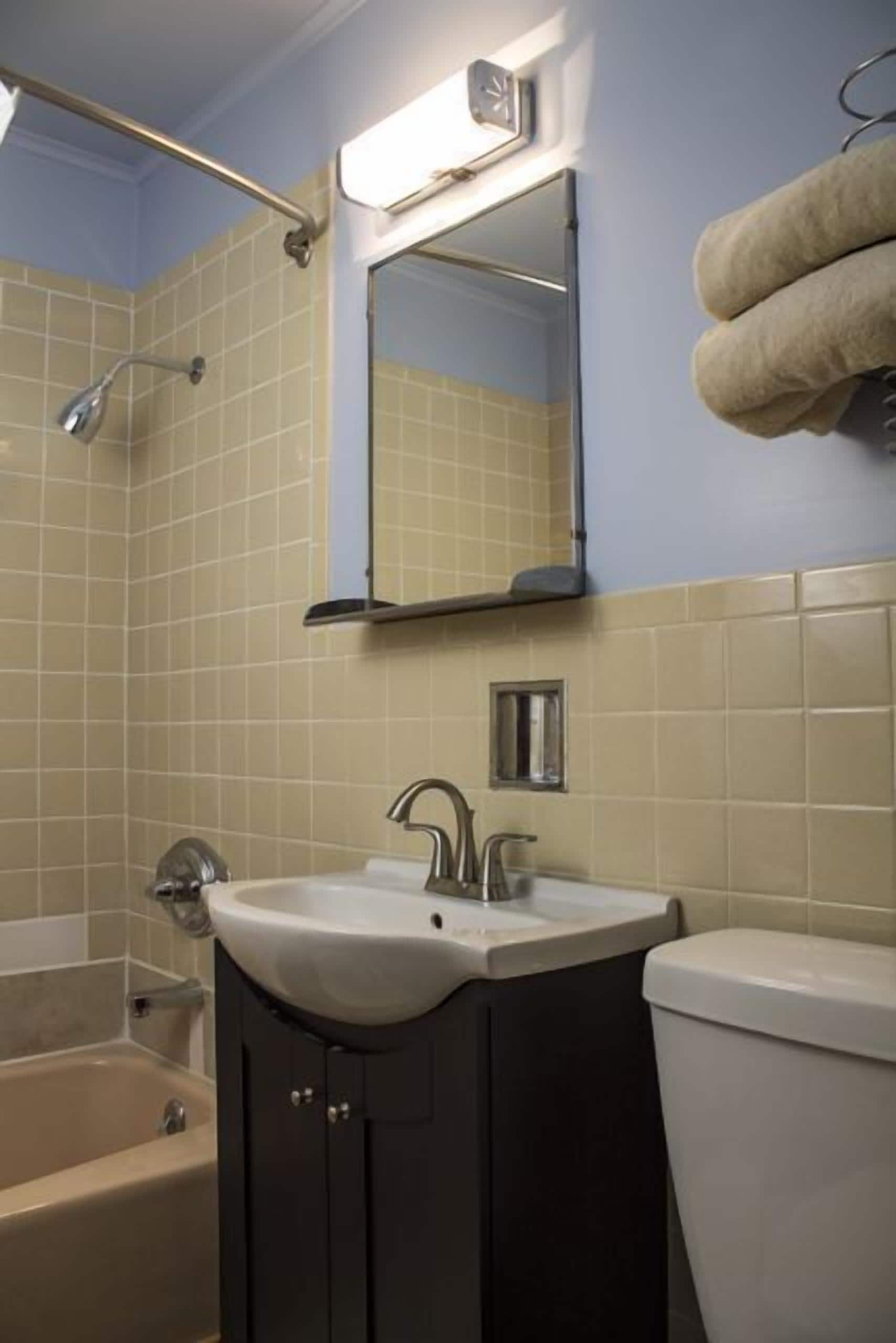 A bathroom with a bathtub, sink, and toilet.