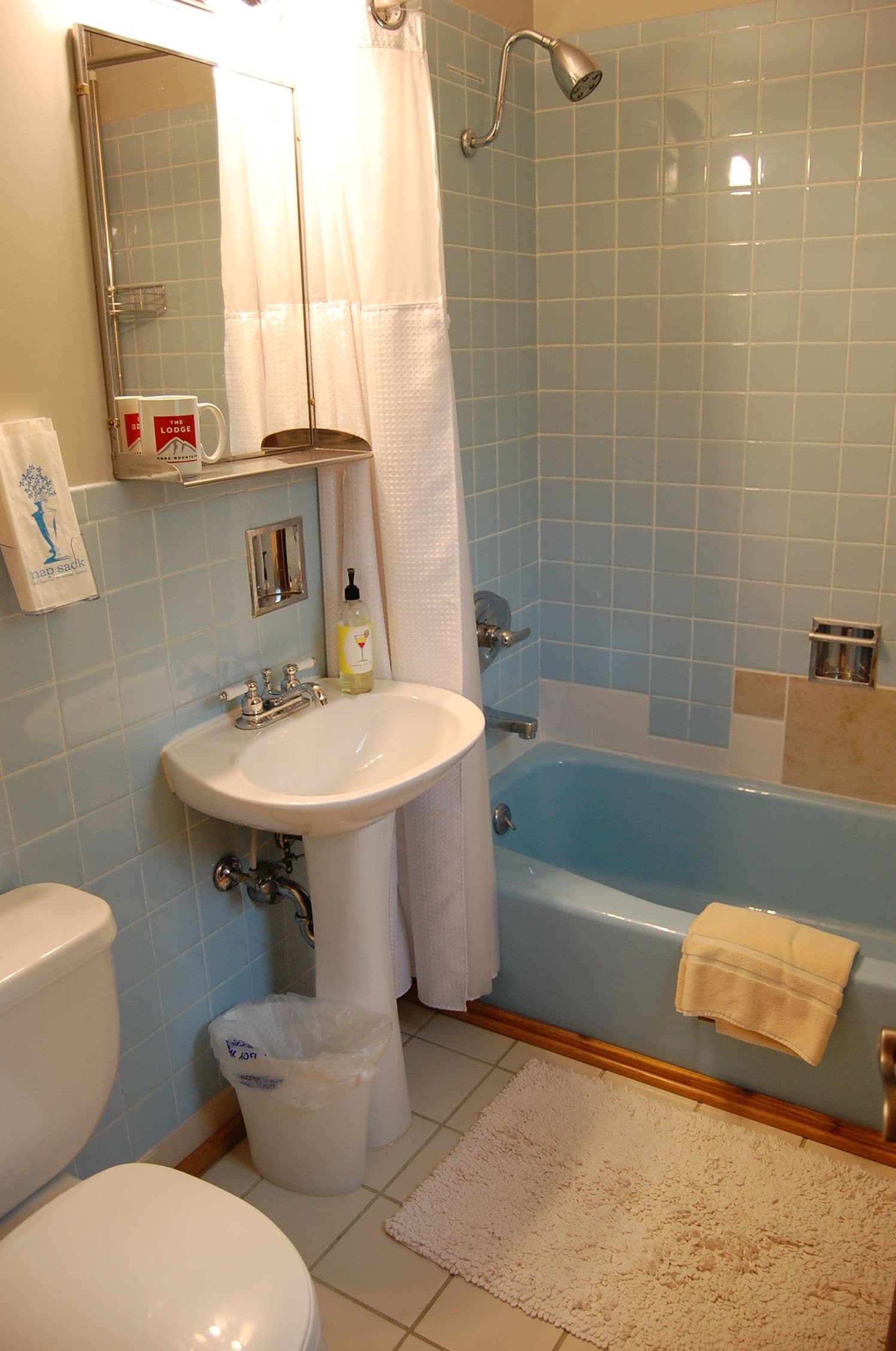 A bathroom with a sink, toilet, and bathtub.