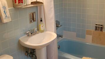 A bathroom with a sink, toilet, and bathtub.