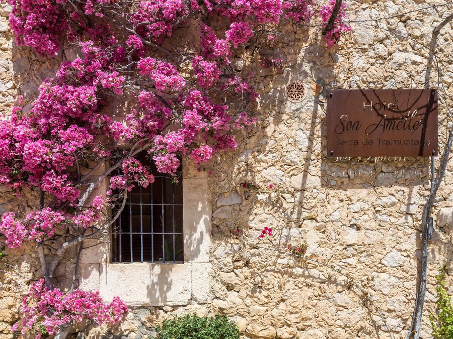 A stone building with a sign reading "Hotel Son Ameiler, Serra de Tramuntana."