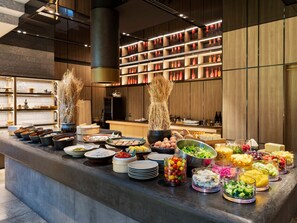 A buffet with various food items and a modern kitchen in the background. - Millennium Mitsui Garden Hotel Tokyo/Ginza (Tokyo)