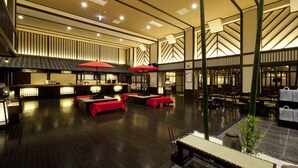 A spacious lobby with a reception area, multiple tables with red tablecloths, and a traditional Japanese aesthetic with wooden flooring and shoji screens. - Air Terminal Hotel (Chitose)