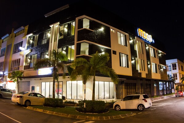 A multi-story hotel with a modern design, featuring large windows and a prominent sign.