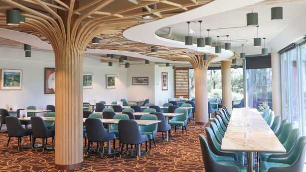 A conference room with a long table, multiple chairs, and a unique ceiling design with wooden beams and hanging lights. - Riverside Oaks Golf Resort (Cattai)
