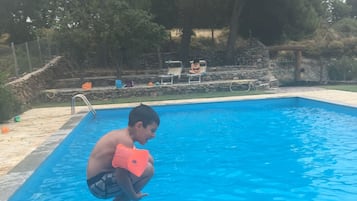 Seasonal outdoor pool, open 9:30 AM to 7:00 PM, pool loungers