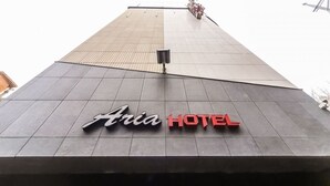 A hotel sign with the name 'Aria Hotel' on a modern building facade. - Hotel Aria Nampo (Busan)