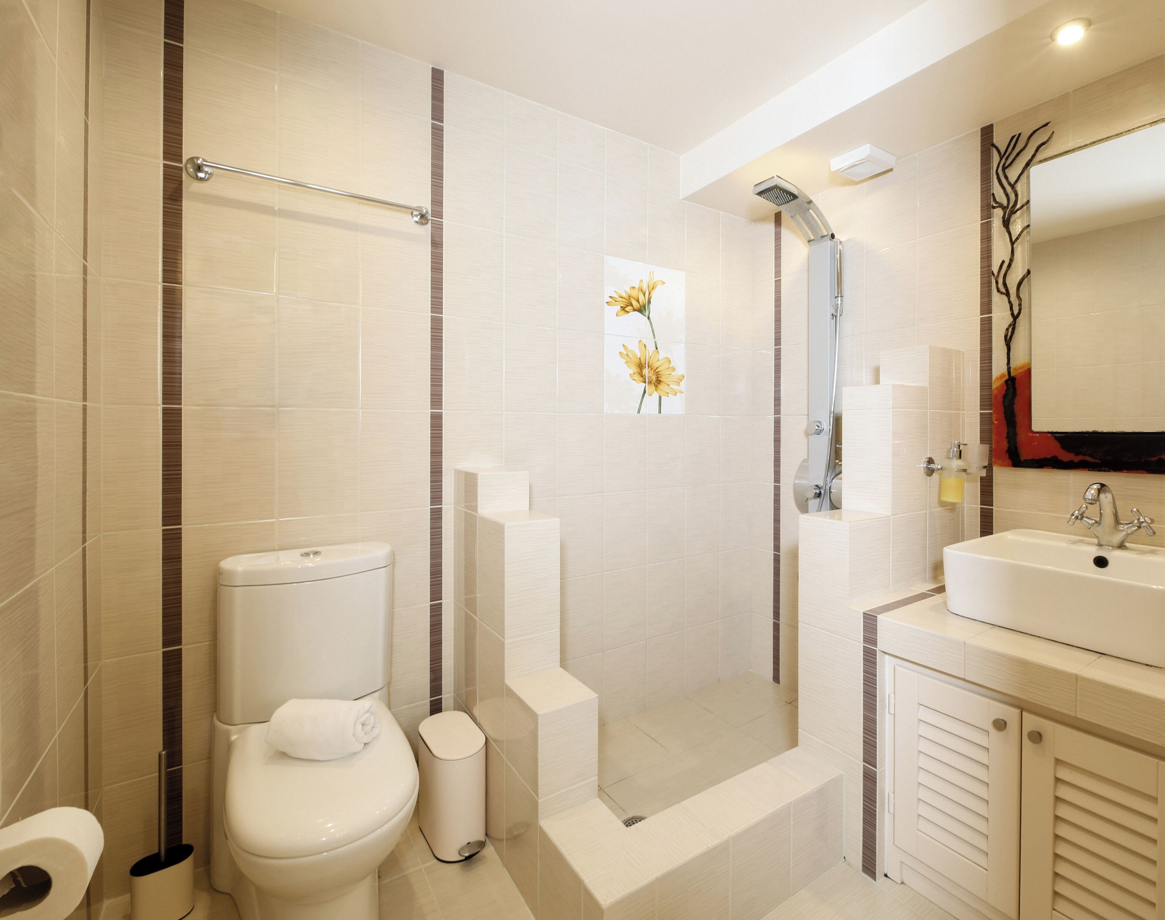 Un baño moderno con inodoro, bidé, ducha y lavamanos.