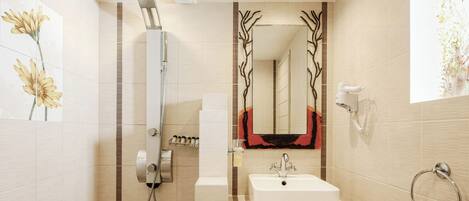 A modern bathroom with a shower, sink, and mirror.