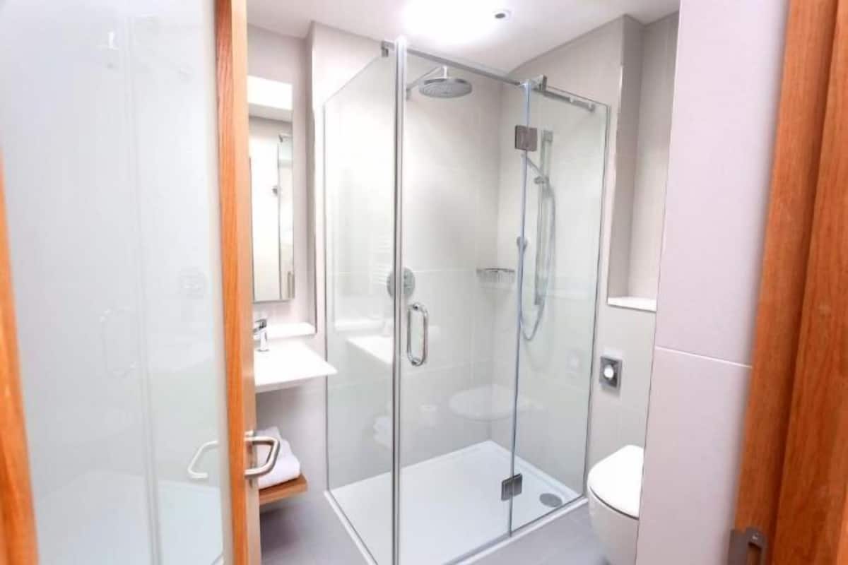 Bathroom | Designer toiletries, hair dryer, towels, shampoo