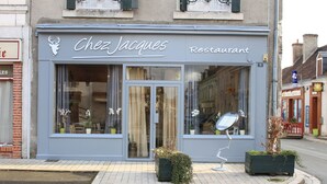 A restaurant named Chez Jacques with large windows and a distinctive sign.